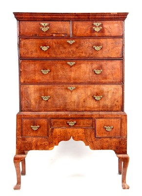 Lot 661 - A QUEEN ANNE FIGURED WALNUT CHEST ON STAND...