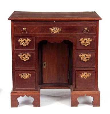 Lot 666 - A GEORGE III FIGURED MAHOGANY KNEEHOLE DESK...