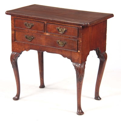 Lot 685 - A GEORGE I WALNUT LOWBOY with cross-banded top...