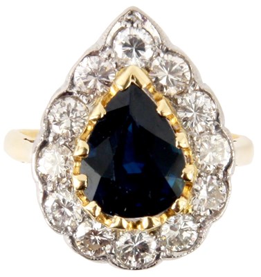Lot 212 - A PEAR SHAPED SAPHIRE AND DIAMOND CLUSTER RING
