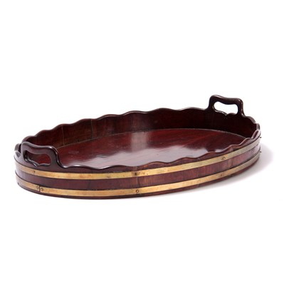 Lot 768 - A GEORGE III BRASS BOUND MAHOGANY OVAL TRAY...