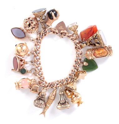 Lot 160 - A 9CT GOLD CHARM BRACELET WITH HEART SHAPED...