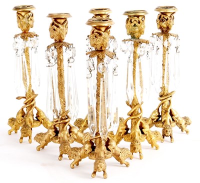 Lot 624 - A SET OF SIX REGENCY ORMOLU TABLE CANDLESTICKS...