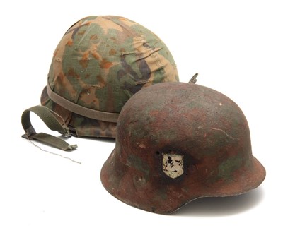 Lot 283 - TWO SECOND WORLD WAR ARMY HELMETS, the...