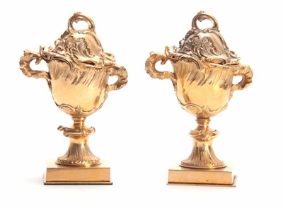 Lot 342 - A PAIR OF ORMOLU ROCOCO LIDDED URNS with leaf...