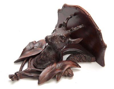 Lot 369 - A CARVED BLACK FOREST SHAPED HANGING BRACKET...