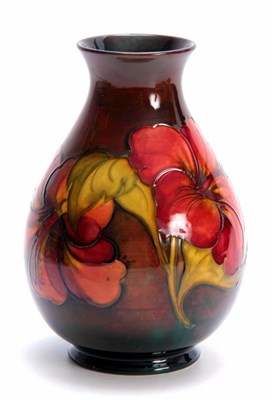 Lot 65 - A WALTER MOORCROFT FLAMBE BALUSTER VASE with...