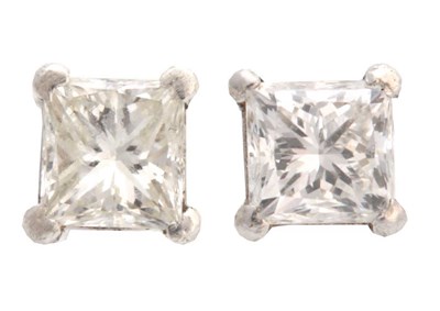 Lot 674 - A PAIR OF WHITE GOLD SQUARE CLAW SET DIAMOND...