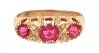 Lot 701 - A 9CT GOLD AND RUBY SET RING having three ruby...