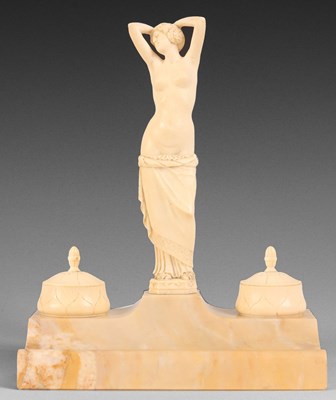 Lot 606 - AN ART DECO CARVED IVORY AND SIENNA MARBLE...