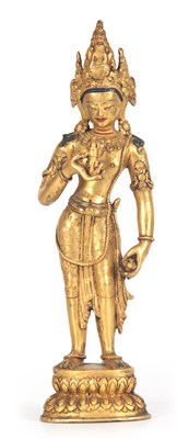 Lot 143 - A TIBETAN STANDING GILT BRONZE FIGURE OF A...