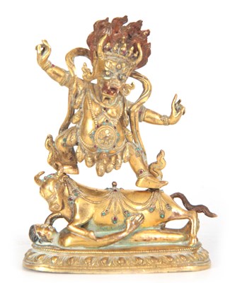 Lot 144 - A TIBETAN JEWELLED GILT BRONZE FIGURE OF A...