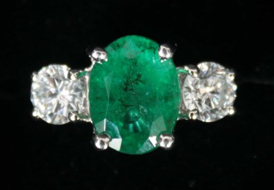 Lot 195 - A PLATINUM, EMERALD AND DIAMOND THREE STONE...