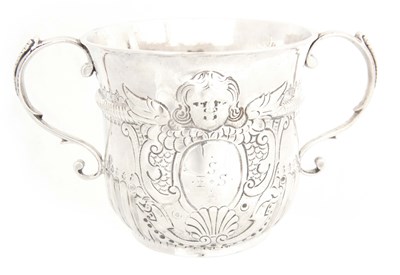 Lot 233 - A QUEEN ANN SILVER PORRINGER the body flanked...