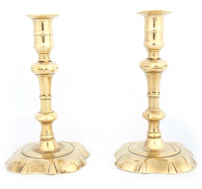 Lot 304 - A PAIR OF 18TH CENTURY CAST BRASS CANDLESTICKS...