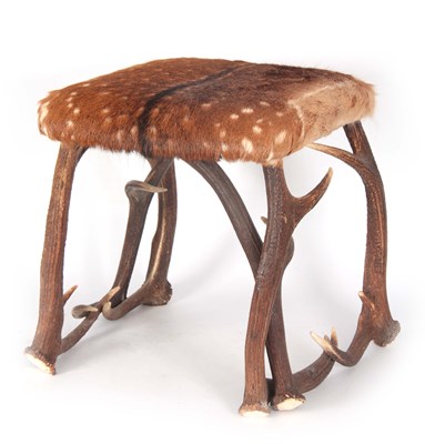 Lot 671 - A FUR COVERED STAGHORN STOOL with...