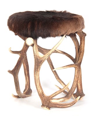 Lot 672 - A FUR COVERED STAGHORN STOOL with...