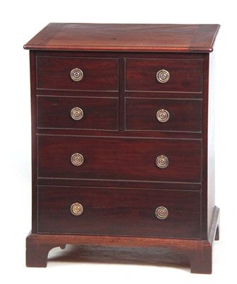 Lot 745 - A GEORGE II MAHOGANY COMMODE with cleated edge...