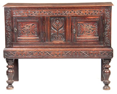 Lot 1049 - A 17TH CENTURY CARVED OAK SIDE CUPBOARD /...