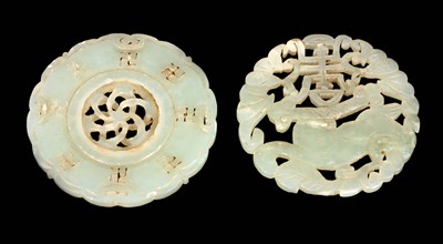 Lot 128 - TWO CHINESE CARVED PIERCED JADE PI DISCS one...