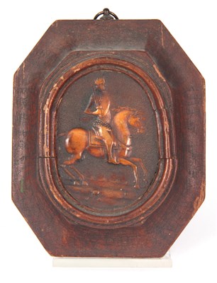 Lot 407 - AN EARLY CARVED AMBER HANGING PLAQUE depicting...