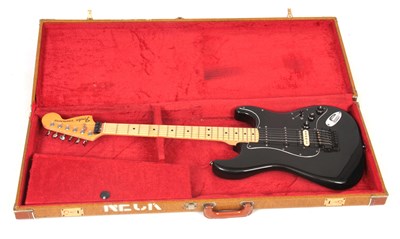 Lot 547 - A BLACK FENDER STRATOCASTER ELECTRIC GUITAR...