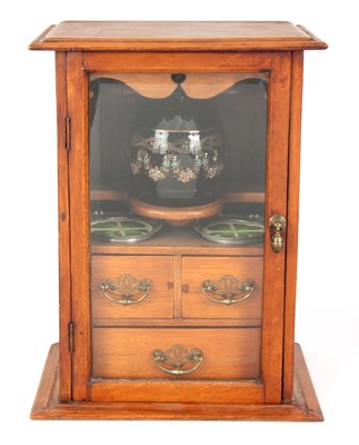 Lot 738 - A STYLISH EDWARDIAN OAK SMOKERS CABINET with...