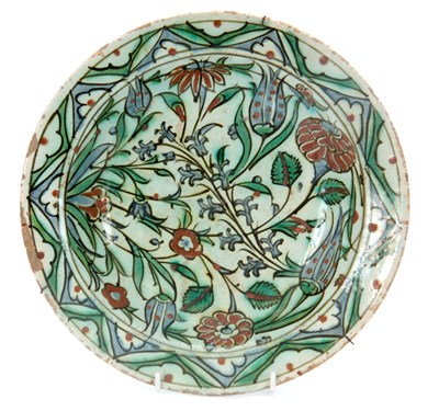 Lot 82 - A 17th CENTURY IZNIK DISH brightly decorated...