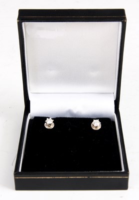 Lot 220 - A PAIR OF SOLITAIRE DIAMOND STUD EARINGS...