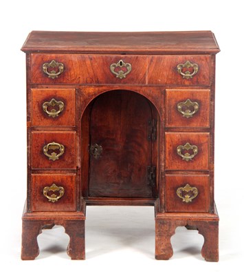 Lot 956 - A GEORGE I WALNUT KNEEHOLE DESK the moulded...