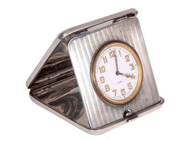 Lot 413 - AN EARLY SILVER TRAVELLING CLOCK the hinged...