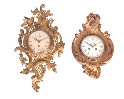 Lot 495 - TWO CARTEL STYLE WALL CLOCKS the larger with...