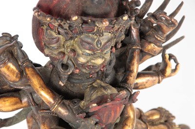Lot 173 - AN EARLY TIBETAN BRONZE MANDKESVARA YAB YUM...