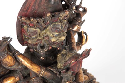 Lot 173 - AN EARLY TIBETAN BRONZE MANDKESVARA YAB YUM...