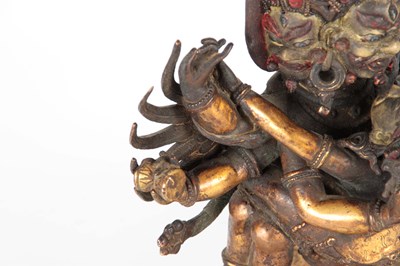 Lot 173 - AN EARLY TIBETAN BRONZE MANDKESVARA YAB YUM...