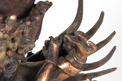 Lot 173 - AN EARLY TIBETAN BRONZE MANDKESVARA YAB YUM...
