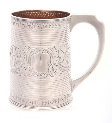 Lot 306 - A GEORGE III SILVER MUG of ribbed tapering...