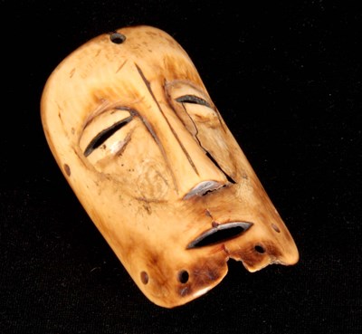 Lot 414 - AN AFRICAN TRIBAL CARVED BONE MASK-HEAD...