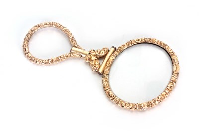 Lot 452 - A LATE GEORGIAN GILT METAL OVAL MAGNIFYING...