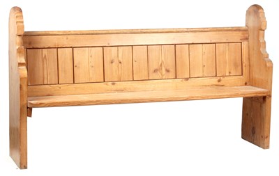 Lot 811 - A 19TH CENTURY PINE CHURCH PEW with shaped...