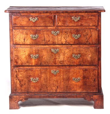 Lot 842 - A GEORGE I FIGURED WALNUT CHEST OF DRAWERS of...