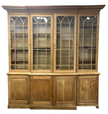 Lot 874 - A 19TH CENTURY PINE BREAKFRONT BOOKCASE with...