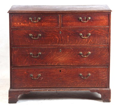 Lot 889 - A GEORGE III OAK CHEST OF DRAWERS fitted two...