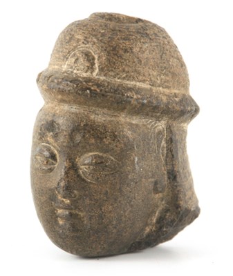 Lot 109 - AN EARLY CARVED STONE TIBETAN HEAD 10cm high.