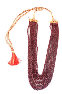 Lot 181 - A GRADUATED RUBY BEAD EIGHT-ROW NECKLACE the...