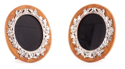 Lot 302 - A PAIR OF GEORGE V OVAL OAK FRAMED AND SILVER...