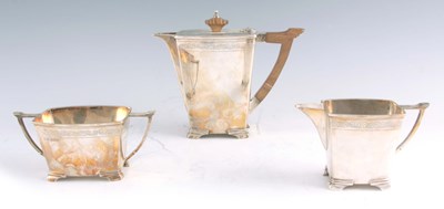 Lot 303 - A GEORGE VI ART DECO SILVER THREE PIECE TEA...