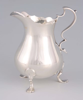 Lot 310 - AN ELIZABETH II SILVER CREAM JUG with shaped...