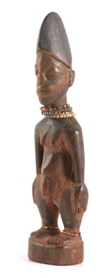 Lot 599 - AN AFRICAN CARVED YORUBA MALE IBEJI with bead...