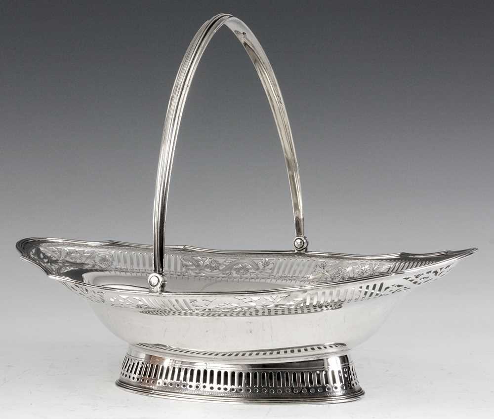 Lot 297 - A GEORGE III LARGE SILVER FRUIT BASKET of oval...